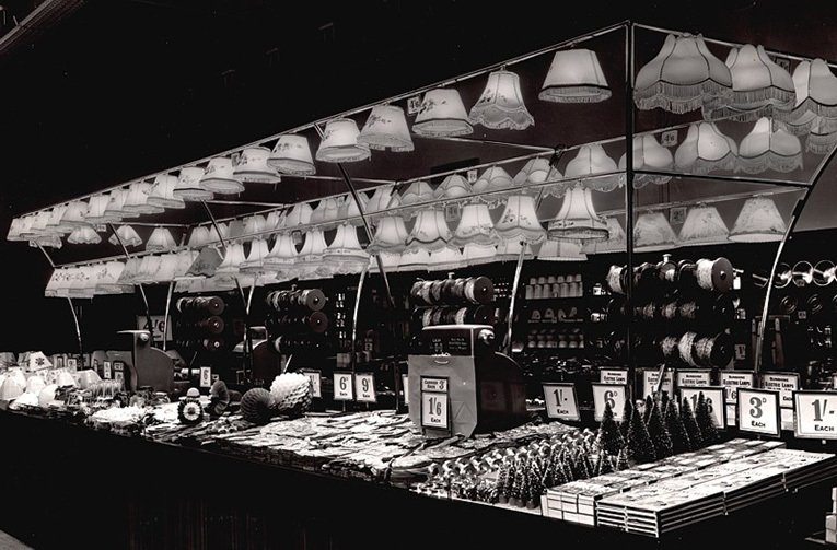 The Christmas Decorations at the Portsmouth store were displayed under the lighting canopy, which was used to sell shades and lamps during the rest of the year. The lights give the decorations an almost surreal shine.  Close inspection will reveal a number of post-war austerity measures which were still in force when the picture was taken in 1950