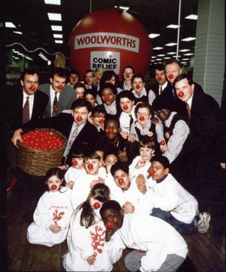 Red Nose Day 1992 - sponsored by Woolworths, with five Directors, Chris Ash, Don Sloan, Dan Bernard, Martin Toogood and Jim Glover posing for photographs behind Edgware Road Store Manager Peter Taylor (holding the basket) and his team