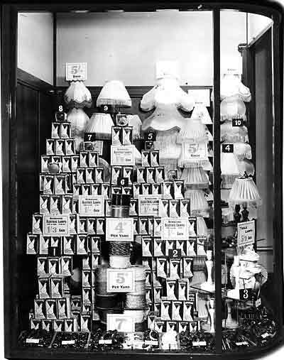 A bold display of Sunshine Electric Lamps, flex and fitments, shades and table lamps captured in a Woolworth's window in 1952