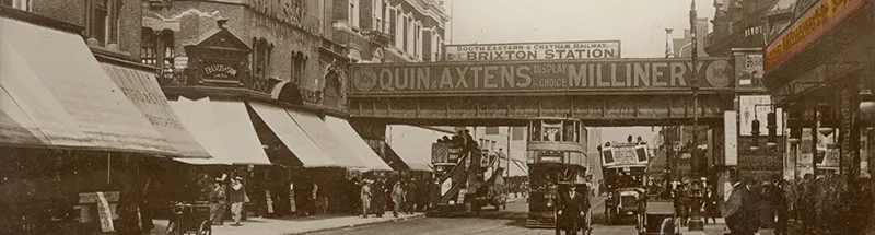 The front entrance to the original Woolworth store in Brixton, looking north under the railway bridge at the corner of Atlantic Road, from a Valentine's postcard sold in-store and postmarked 1919