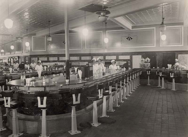 A state-of-the-art Quick Service Tea Bar on the ground salesfloor of the Woolworth superstore in Portsmouth, Hampshire, England, pictured in 1930. Many would argue that this was the retailer's catering at its very best, cheap and affordable, yet ultra modern and stylish. Construction had seen perhaps the highest ever co-operation across the Atlantic between Executives in New York City and their normally fiercely independent counterparts in London, England