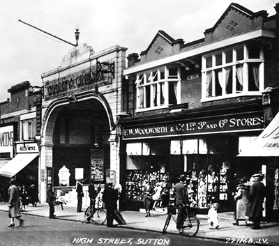 From a Valentine's postcard sold inside for threepence, a view of the original Woolworth store at 96 High Street, Sutton in Surrey, with the Gaumont British cinema right next door