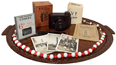 A selection of bakelite items, including an elegant, thin oval 16in (41cm) tray, two bakelite necklaces, and the best-seller an exclusive VP Twin Pocket Camera with a B.O.L.Co. Optically Ground Lense