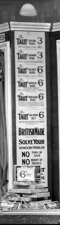 Signage in the window display created by Phil Picot for the re-opening day of the enlarged F.W. Woolworth store in Clapham Junction, London, SW11 in 1926. As ever, nothing was over sixpence.