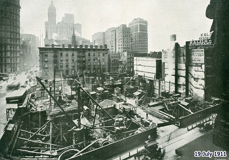 Construction of the Woolworth Building - the working platform at street level and a general view of the site. The picture was taken on 19 July 1911 and appeared in 'Engineering' Magazine on 5 January 1917